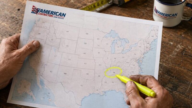 Contractor circling Tennessee with a yellow highlighter on an American Contractors Exam Services US licensing map